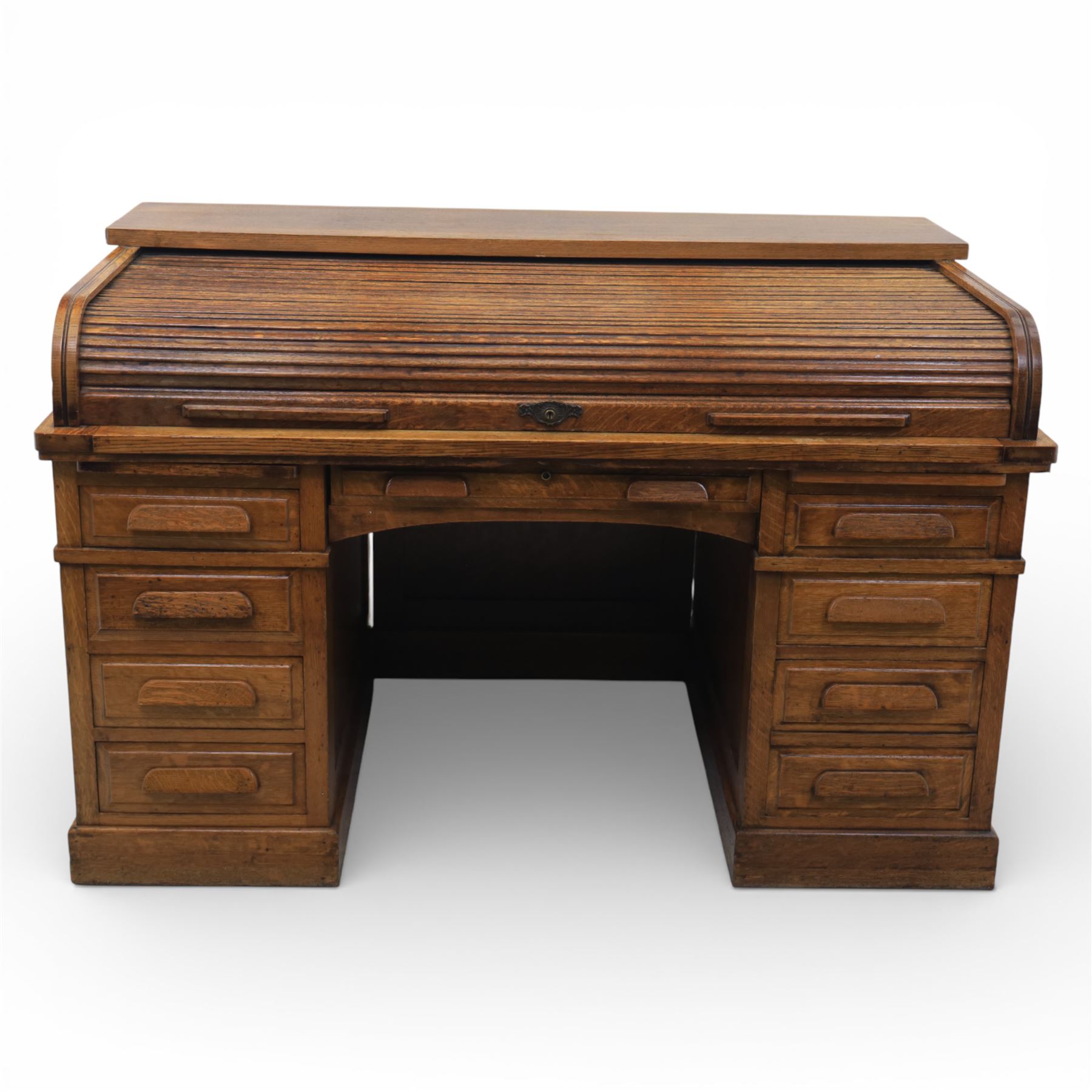 Globe Wernicke - Oak roll top desk, fitted with nine drawers, oak tambour roll top revealing a fitted interior, with single frieze drawer, flanked by four drawers to each pedestal, on a plinth base