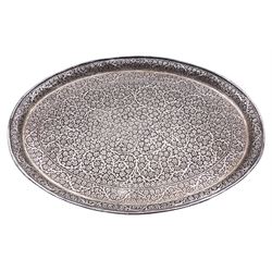 Early 20th century Middle Eastern silver tray, of oval form, with repousse and chased floral and foliate decoration, with engraved plaque to underside
