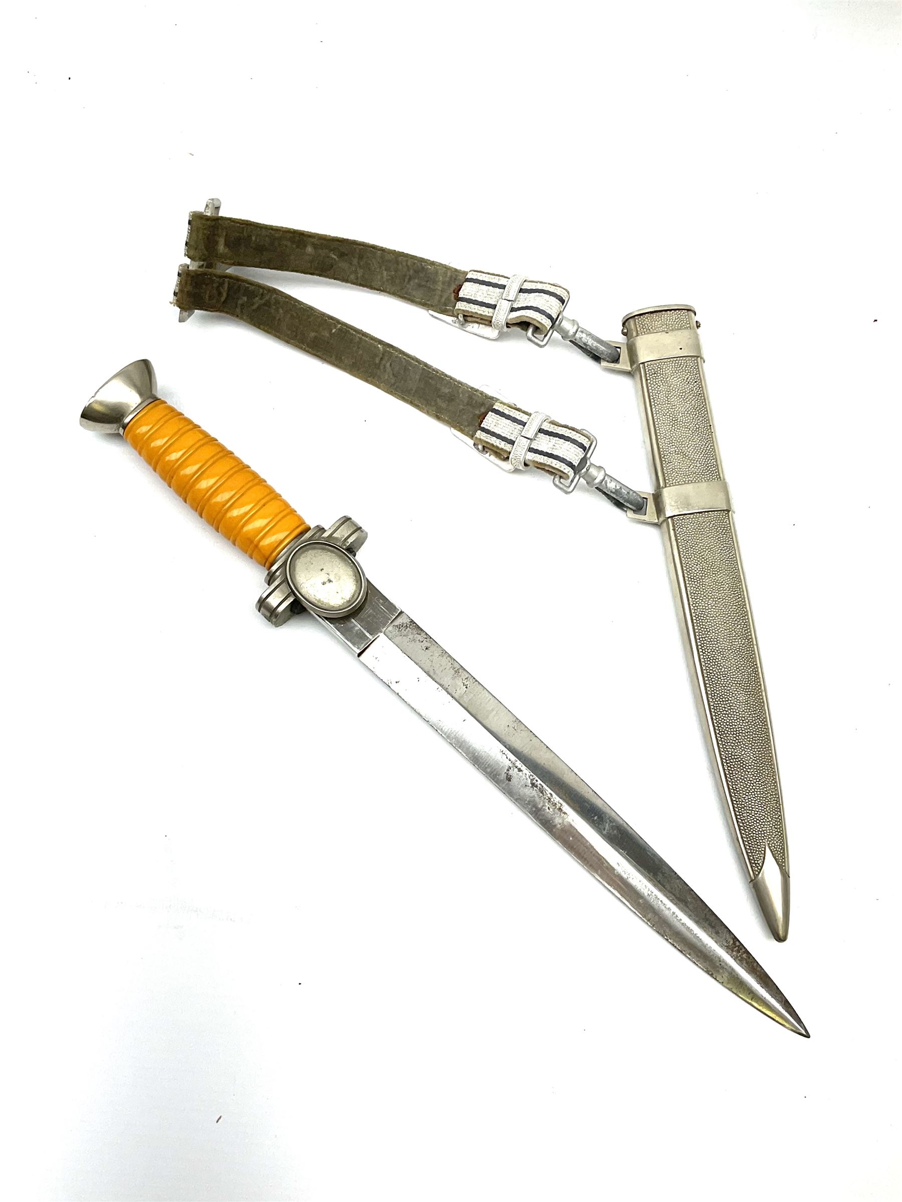 WW2 German Deutsches Rotes Kreuz (Red Cross) Leader's dagger with unmarked 24.5cm double edged steel blade, white metal hilt with cut-down oval langet and ribbed orange plastic grip, the hammered white metal scabard with slightly off-set square suspension rings and silvered/silver thread hanging straps L39cm