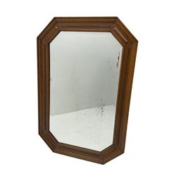 Edwardian oak framed octagonal wall mirror, bevelled plate with beading design 