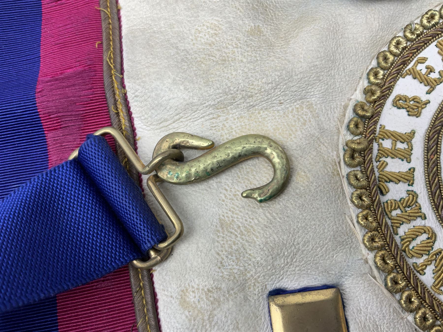 Two Masonic kid leather aprons, one with sash and cuffs, the other with sash, each marked 'Yorkshire North and East Ridings'; and three other unmarked Masonic aprons with sashes