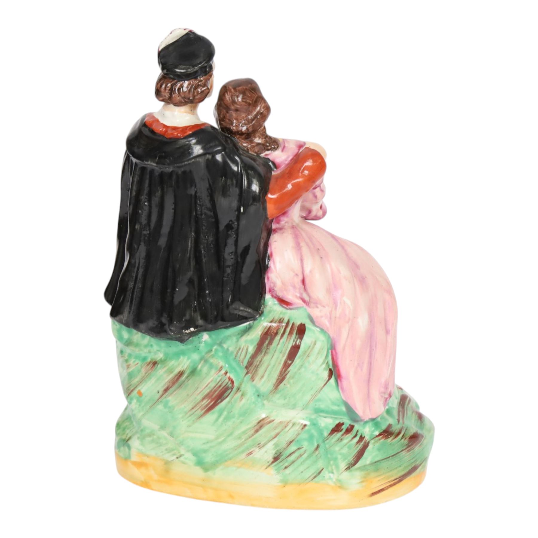 Rare Staffordshire pottery figure group, circa 1852, modelled as Romeo and Juliet, both seated upon a naturalistic base with their arms around one another, Romeo wearing cloak and plumed hat, Juliet in long dress, H20cm
