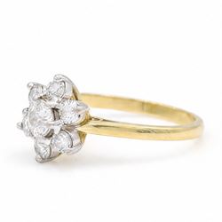 18ct gold diamond flower head cluster ring, principal round cut diamond of approx 0.55 carat, surrounded by six round brilliant cut diamonds, hallmarked, total diamond weight 1.15 carat