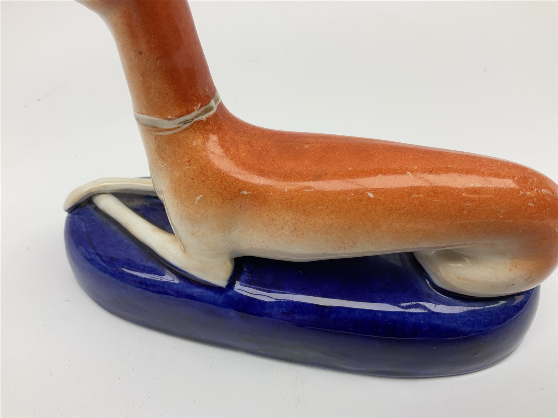 Pair of Staffordshire recumbent greyhound pen holders 