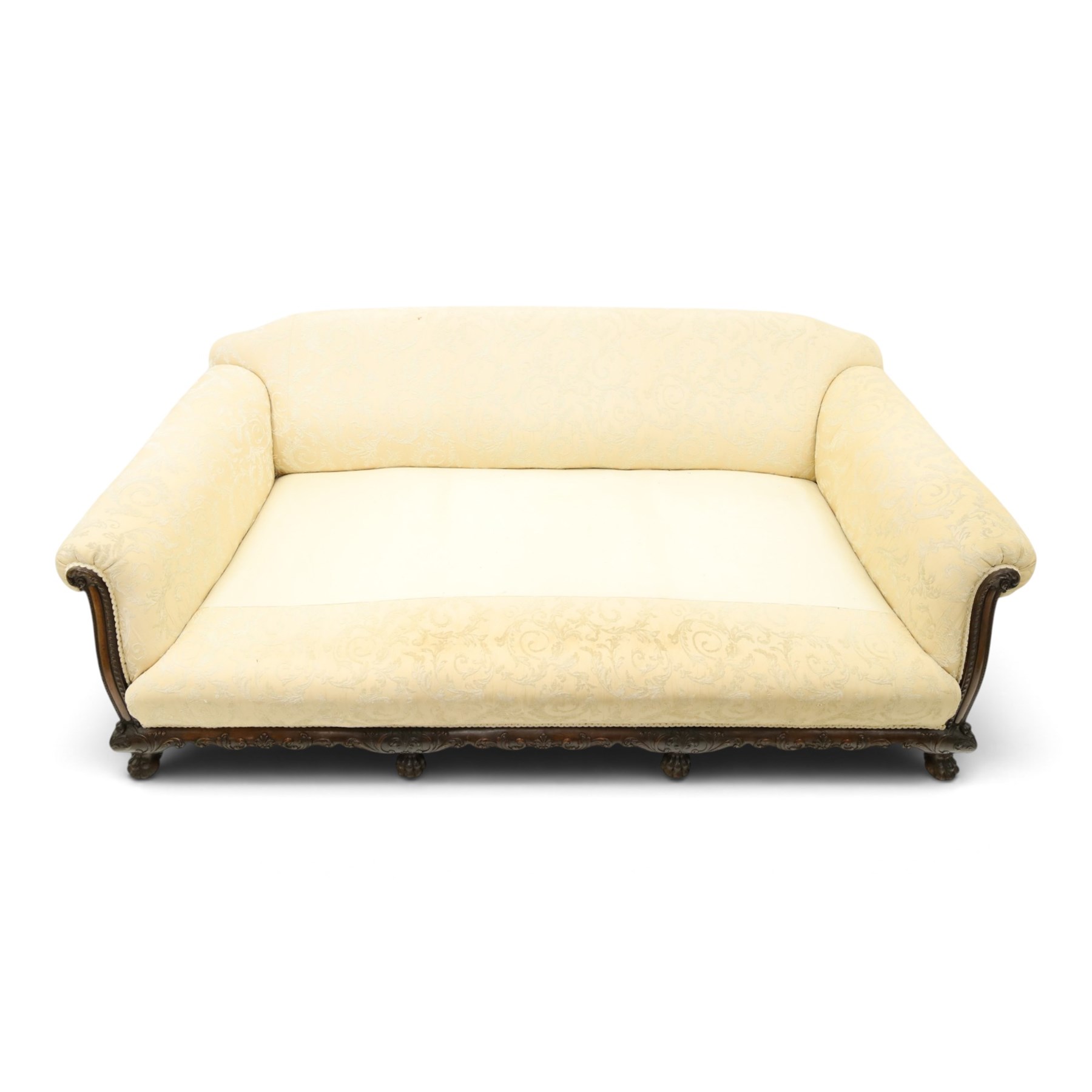 Quality Edwardian carved mahogany lounge suite comprising three-seater settee and pair of armchairs, the sofa with arched back over rolled arms and deep sprung seat, the arm terminals carved with acanthus rosette over gadroon and rope-twist moulding, the shaped apron carved and moulded with scrolling foliate acanthus motifs, terminating to four large front hairy paw and ball feet, upholstered in pale yellow foliate fabric with matching seat and scatter cushions (W200cm D105cm H73cm); the matching deep armchairs (W78cm D95cm H75cm)