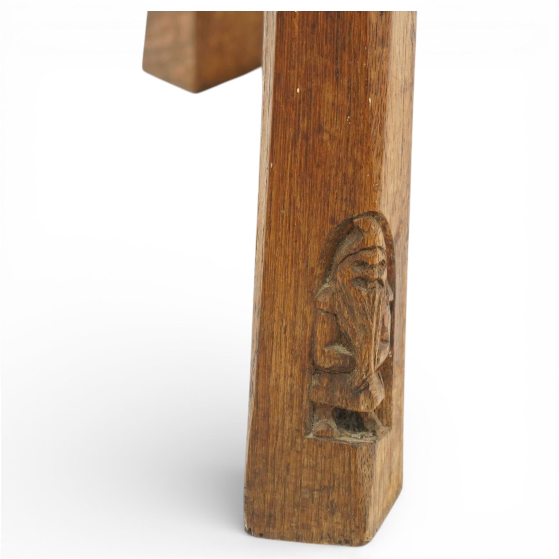 Gnomeman - oak circular stool, the top carved with continuous rosette and scrolling border, raised on three splayed supports, one leg carved with gnome signature, by Thomas Whittaker of Littlebeck