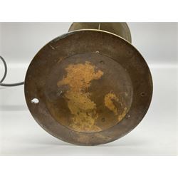 Arts & Crafts Jesson, Birkett & Co, brass table lamp or wall light, designed by Thomas Birkett, the tapering stem with adjustable ball pivot supporting a conical shade with tapering final with ball terminal, upon a circular domed base pierced for wall mounting, shade positioned upright overall H57cm

Often misattributed to Arthur Stansfield Dixon for Birmingham Guild of Handicraft, this particular lamp was designed by Thomas Birkett.
In the late 1890's Birkett worked as a metalwork at the Birmingham Guild, before later joining the Faulkner Bronze Company which went on to become Jesson, Birkett & Co in 1904. The lamp features in lighting catalogues from the firm under the model no E490.

