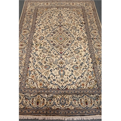  Kashan beige and blue ground rug, repeating border, floral field, central medallion, 300cm x 197cm  