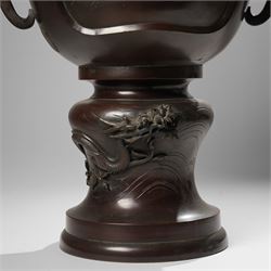Japanese late Meiji period bronze koro and cover, surmounted by an eagle finial and with bird decoration in high relief to each side, twin elephant trunk handles, bearing indistinct character signature to one side, H82cm