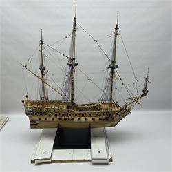 Wooden kit built model of HMS Neptune, 1:90 scale, with detailed rigging to three masts and a row of cannons to either side, upon ebonised wooden base, including stand H71cm