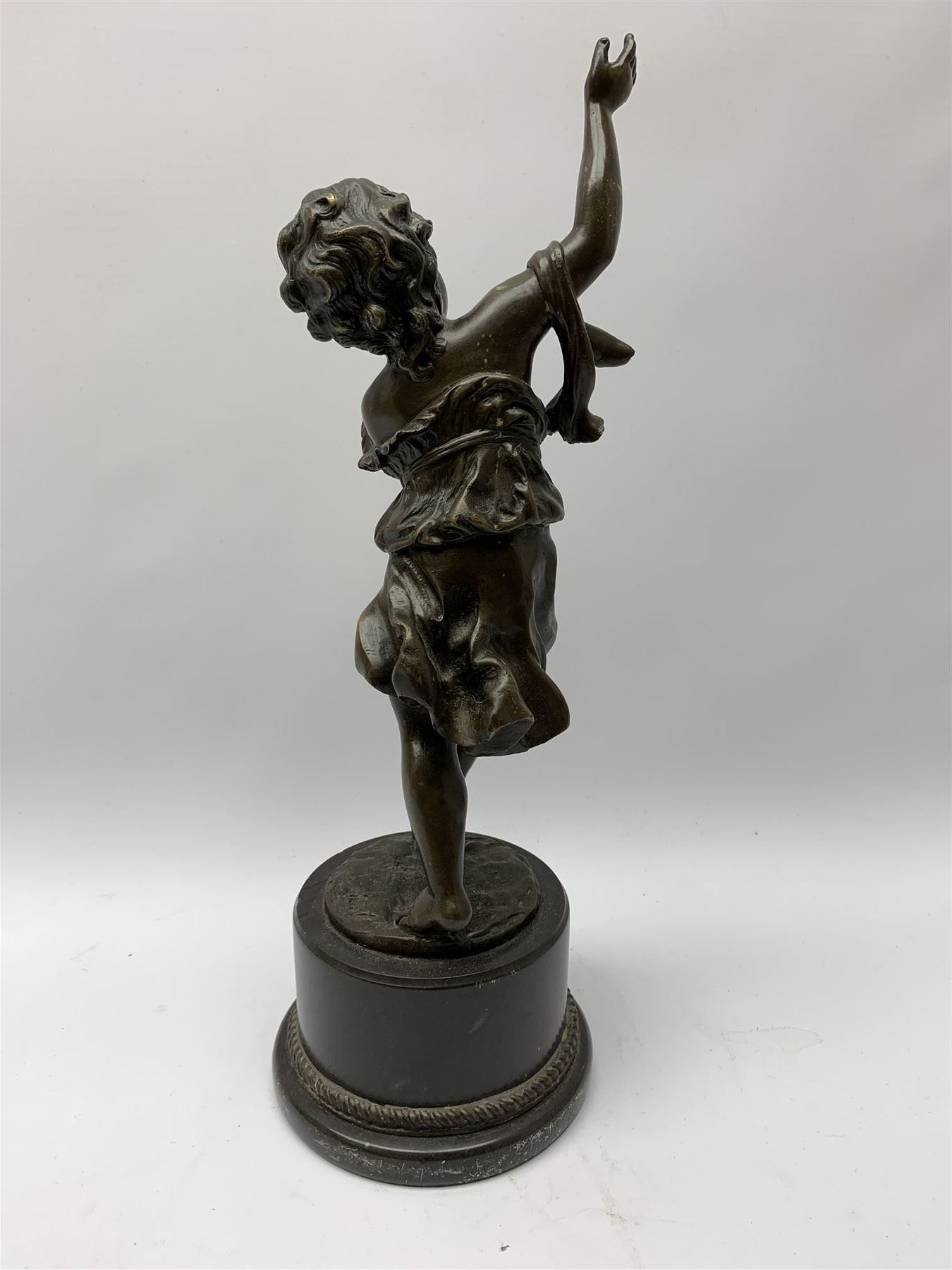 After E Plat, bronze modelled as a dancing child, signed E. Plat, upon cylindrical black marble base, H40cm