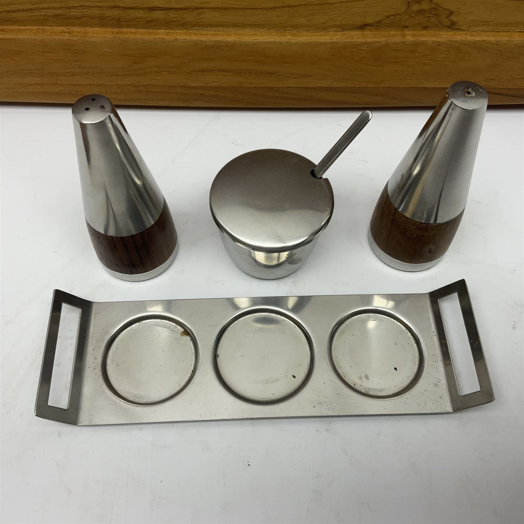 Danish collectables, to include teak tray by Nissen Denmark, ladybird pattern biscuit barrel by Laurids Lonborg and a Stelton stainless steel and wooden cruet set, together with a mid century floral tile trivet