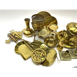 A group of assorted brassware, to include pair of lamp bases, further lamp, number of candlesticks and chamber sticks including a pair, kettles, planter, vase, trivets, etc. 