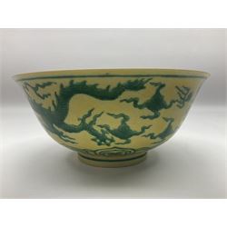 Pair of Chinese famille jaune bowls, decorated in green enamel with a dragon chasing a flaming pearl amongst clouds, upon a yellow ground, the interior decorated to centre with dragon, with six character mark beneath, D17.5cm