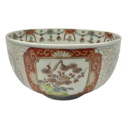 Late 19th/early 20th century Japanese bowl, the exterior decorated with alternating roundels of cranes amongst cloud motifs and stylised panels of foliate branches with iron red borders, D11cm