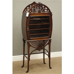  Edwardian mahogany music cabinet, arched carved and fret work pediment and apron, on slender angular splay legs with stretchers, single door enclosing five divisions, W54cm, H131cm, D30cm  