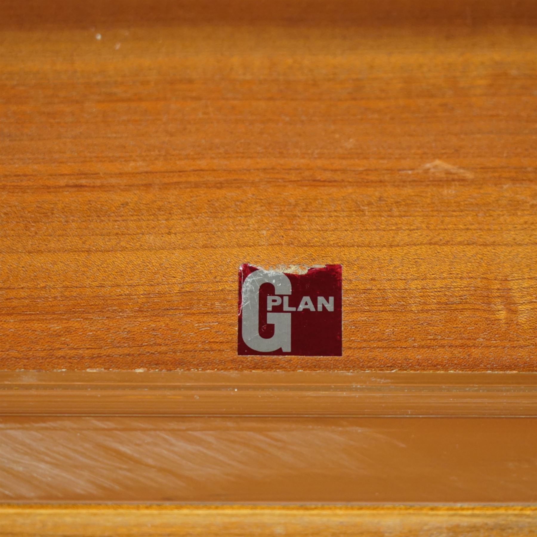 G Plan - 'Form 5' teak modular bookcase unit, comprising two upright sections with upper cupboard compartments enclosed by hinged doors, open adjustable shelving below, fitted with a pair of central drawers to each section, raised over a long base cabinet with sliding cupboard doors