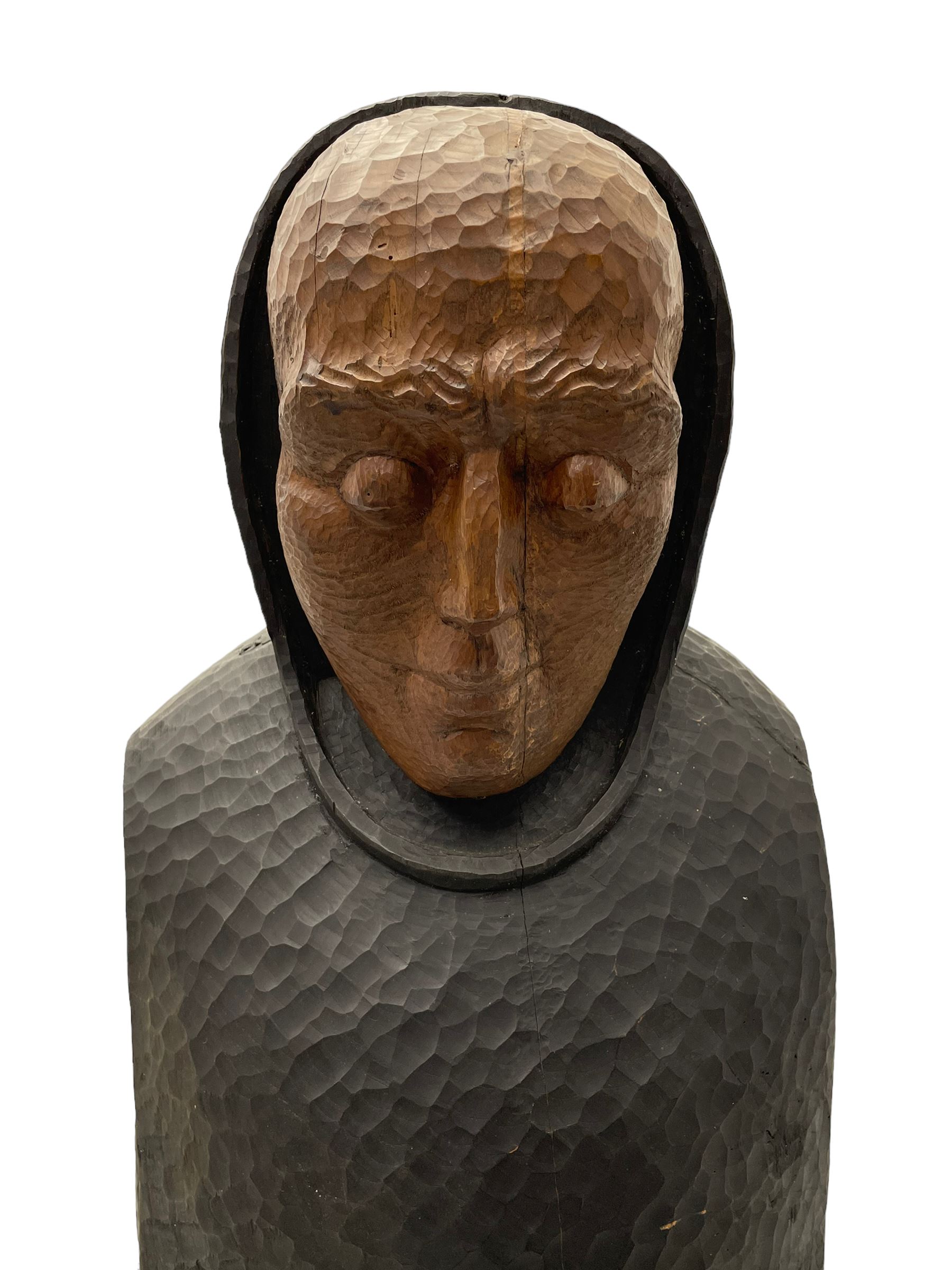 John Bunting FRBS, FRCA (1927-2002): Carved sculpture of a standing Monk in ebonised robes