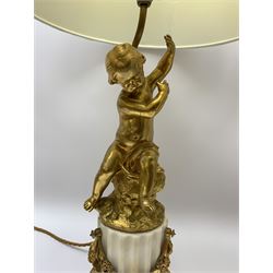 Pair of 19th century style ormolu table lamps, the stems formed as putto seated upon naturalistically modelled stumps, each upon fluted marble column base detailed with ormolu floral swag, and hexagonal plinth with ormolu band, with white fabric shades, H46cm