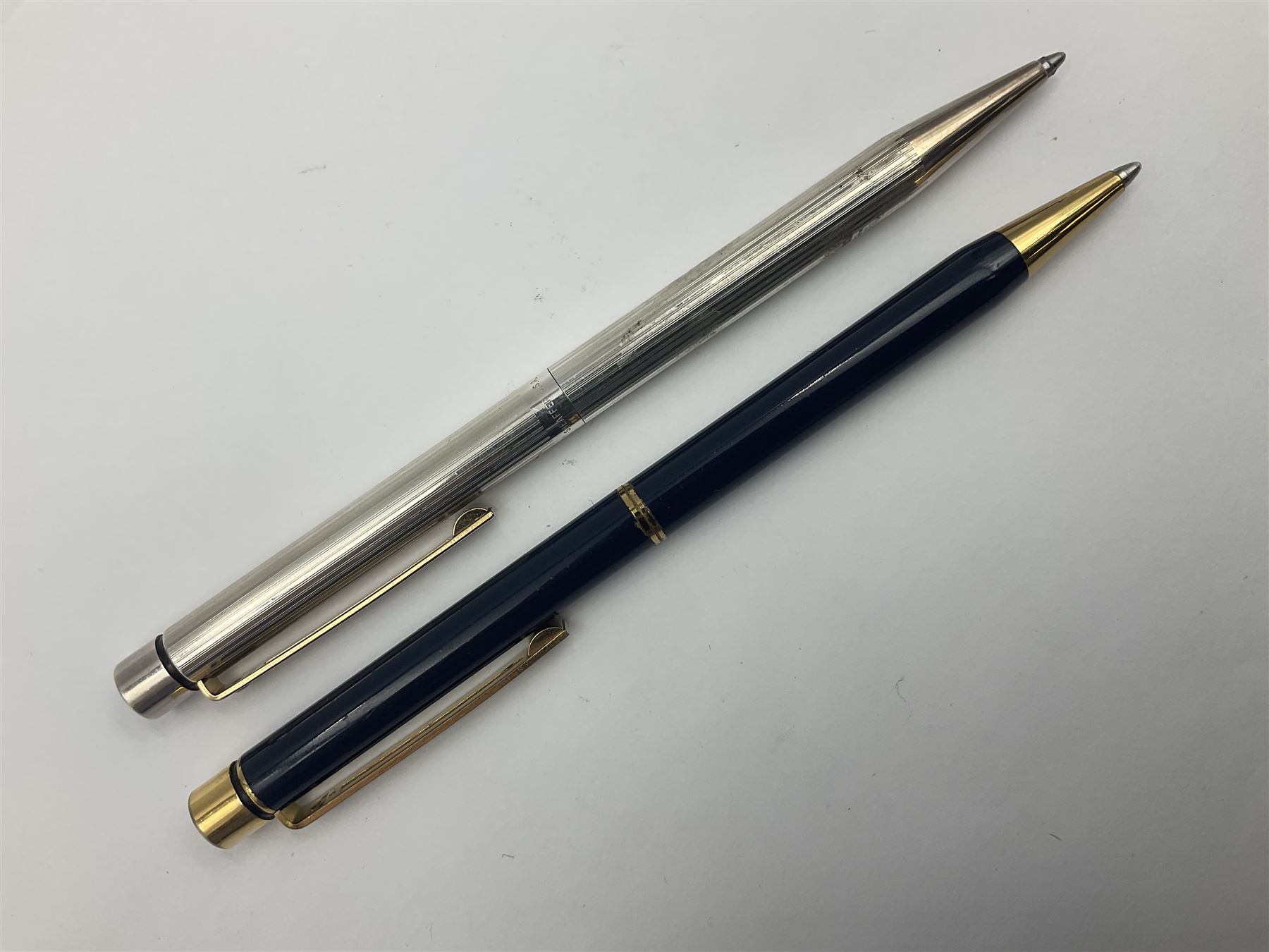 Sheaffer Targa 1011 Diamond Square fountain pen, the gold plated barrel with nib stamped 14K 585, together with another Sheaffer Targa fountain pen with blue barrel and gold nib stamped 14K 585 and matching ballpoint, and Sheaffer ballpoint pen with sterling silver barrel, largest L13.5cm (4)