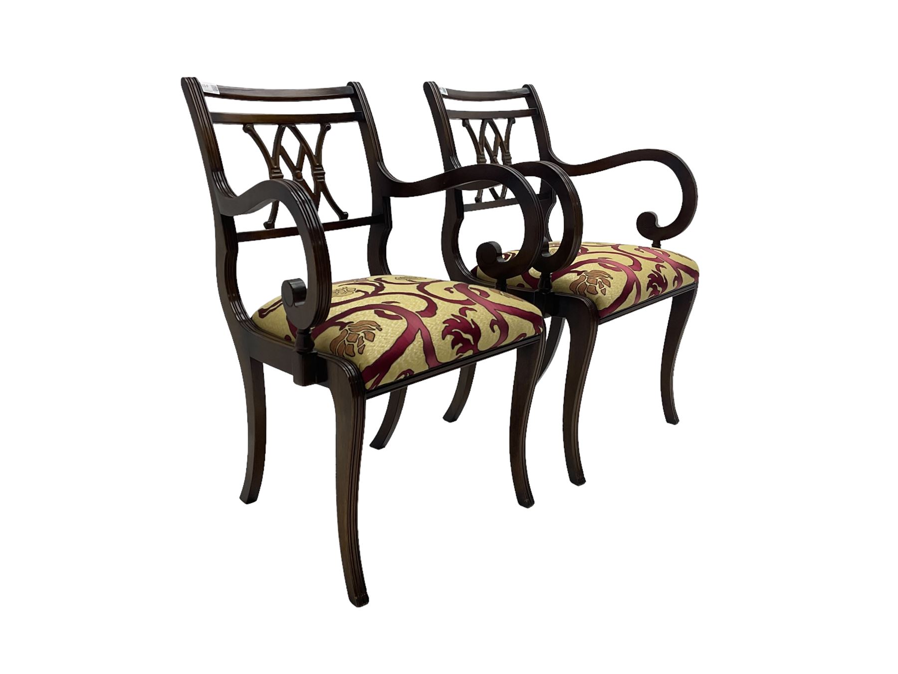 Regency design mahogany twin pedestal dining table, rectangular top with reeded edge, acanthus carved turned column terminating in reeded tripod base with hairy paw feet and castors (W172cm D92cm H75cm) and set eight (6+2) Regency design mahogany dining chairs, pierced back with scroll design, seat upholstered in patterned laurel green fabric, raised on reeded sabre supports (W48cm H88cm)