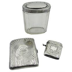 Edwardian silver cigarette case, of rounded rectangular form engraved with central circular panel with monogram and radial sun burst design, hallmarked Robert Pringle & Sons, Birmingham 1908, H8.5cm W7cm, together with an Edwardian silver vesta case, engraved with vacant cartouche and scrolling foliate surround, hallmarked Sydenham Brothers, Birmingham 1904, and a Victorian glass dressing table jar with silver cover, hallmarked London1889, makers mark worn and indistinct, approximate total silver weight 3.83 ozt (119.2 grams)