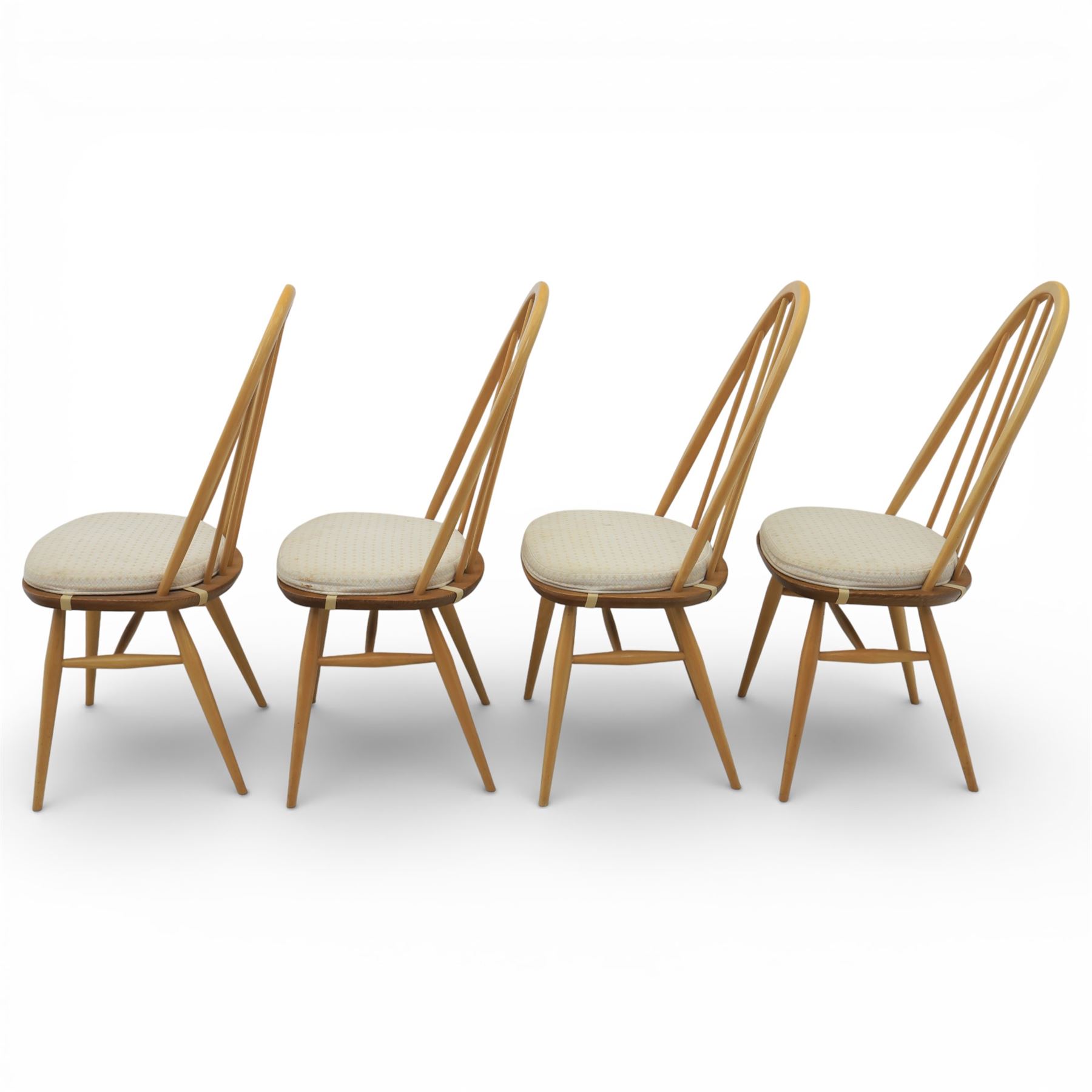 Ercol - elm dining chairs, set of six including two armchairs, arched spindle backs over shaped elm seats with upholstered pads, tapering beech legs joined by stretchers