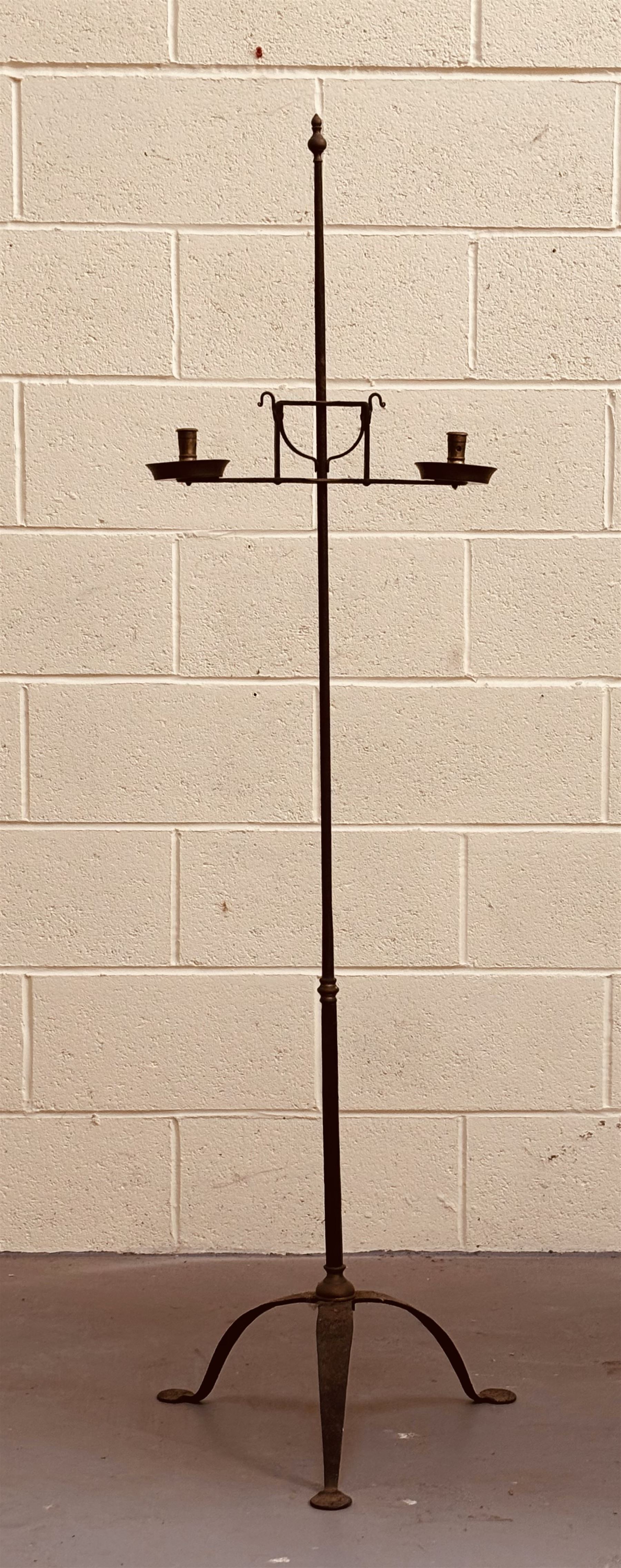Brass mounted wrought iron two branch candle stand on a tripod base, possibly American. H162cm.  - COLLECTION BY APPOINTMENT FROM: The White House, Thirsk Road, Easingwold, York, YO61 3NF - CALL 01723 507111 TO ARRANGE