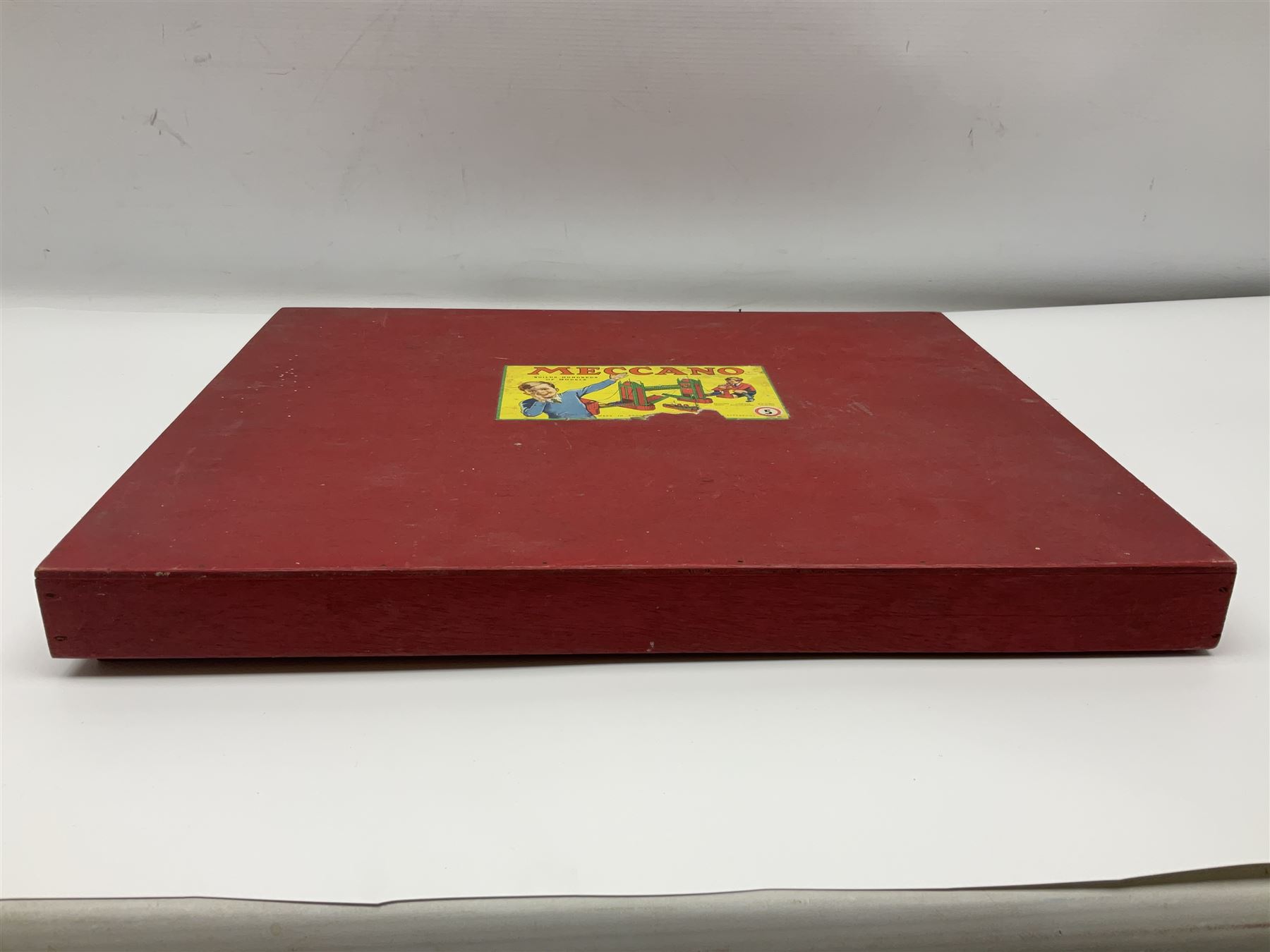 Meccano Set No.5 wooden box containing quantity of predominantly red and green sections, parts, brackets, wheels etc and instruction booklet