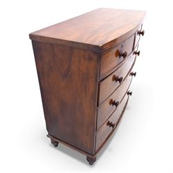 19th century bow front mahogany chest of drawers, rectangular top with moulded edge above an arrangement of two short and three long graduating drawers with turned wooden handles, raised on turned feet