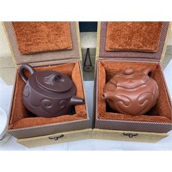 Two Chinese Yixing teapots, Chinese tea bowl hand painted with figures reading, another tea bowl with with underglaze floral panel and another tea bowl with saucer and lid, together with other teacups etc all boxed and with character marks