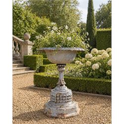 Small ornate painted 19th-century Meadow Foundry cast iron centrepiece urn, with wide, scalloped bowl rim decorated with a repeating egg and dart decoration, supported on a slender fluted pedestal with raised quatrefoil design on an octagonal plinth base  