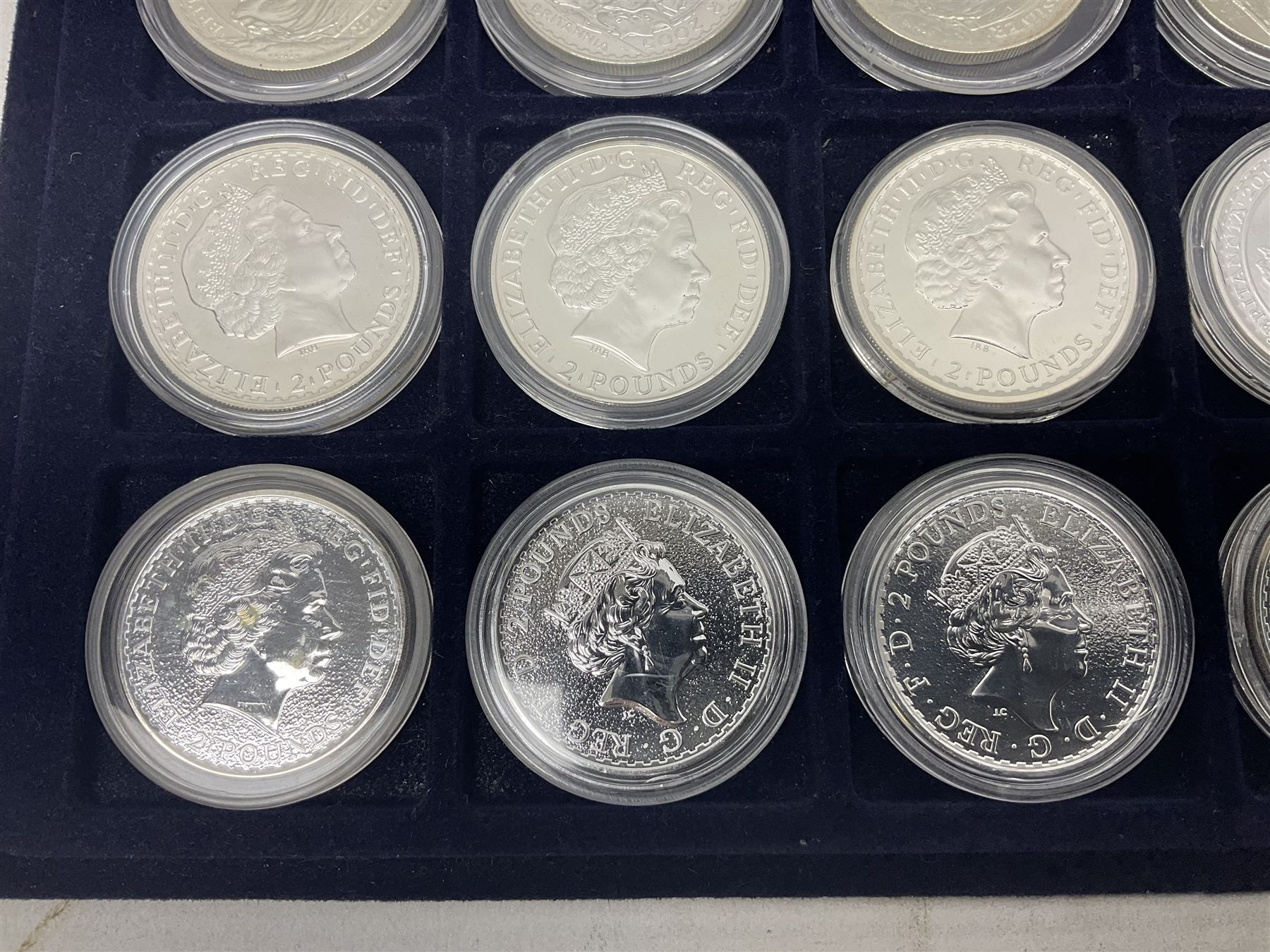 Twenty-four Queen Elizabeth II Britannia one ounce fine silver two pound coins, dated 1998, 1999, 2000, 2001, 2002, 2003, 2004, 2005, 2006, 2007, 2008, 2009, 2010, 2011, 2012, 2013, two 2014, 2015, 2016, 2017, 2018, 2019 and 2020 (24), housed on a coin tray