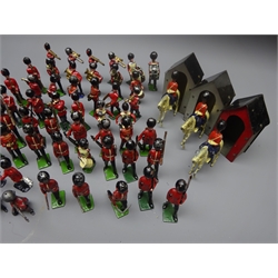  Over fifty Queen's guard die-cast figures by Britains etc including drummers and other band members, standing, kneeling, on horseback etc and three sentry boxes  
