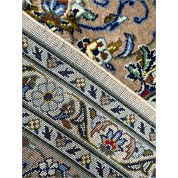 Persian Kashan ivory ground carpet, central medallion on a field of scrolling foliate branches decorated with palmettes, the border decorated with repeating stylised plant motifs, floral design guard stripes