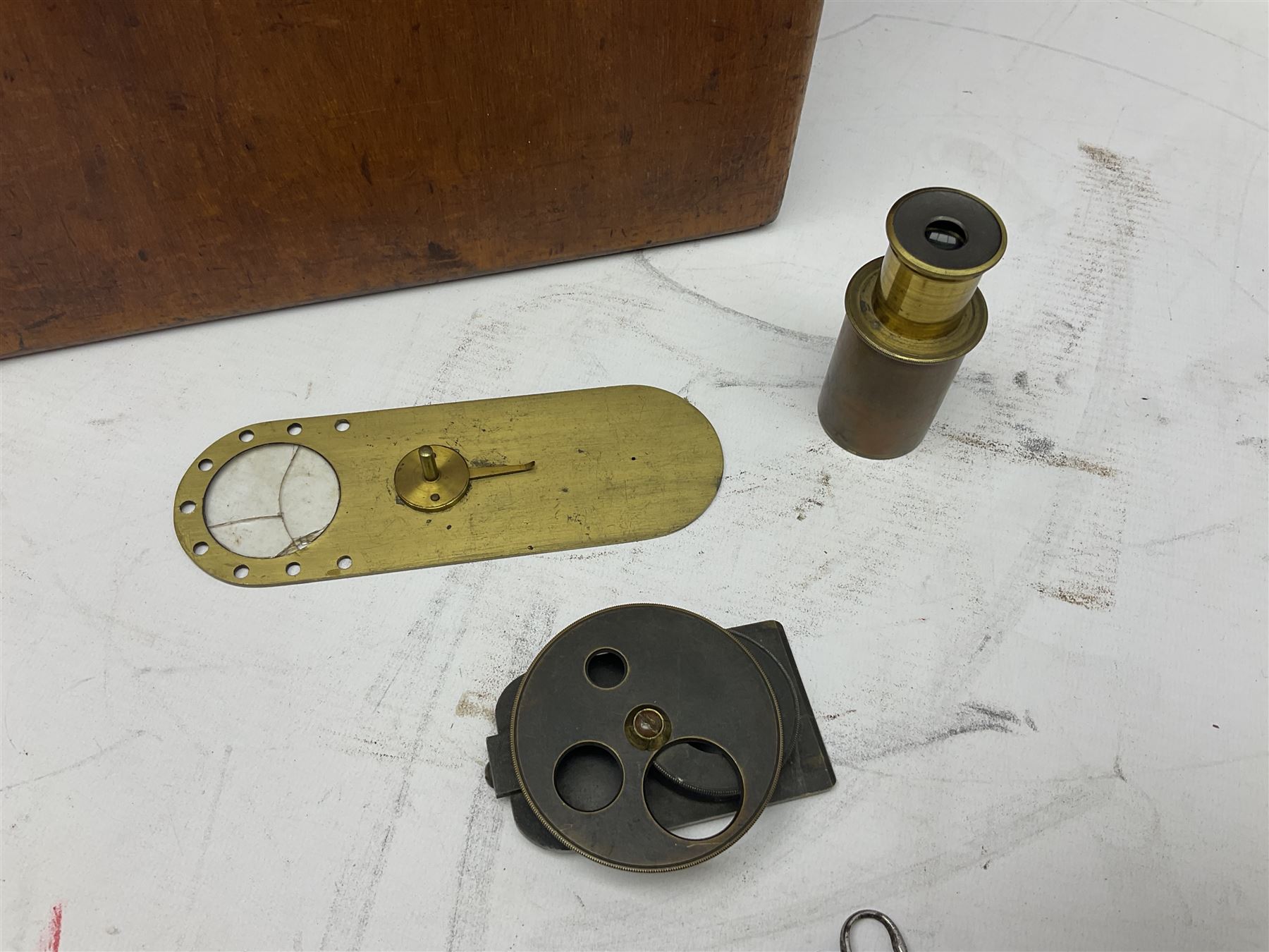 Mid 19th century brass monocular microscope by Andrew Ross, London No.180, with pitchfork base, rack and pinion focusing, revolving bed and swivelling barrel, with accessories, housed in a mahogany case with recessed carry handle and lockable doors