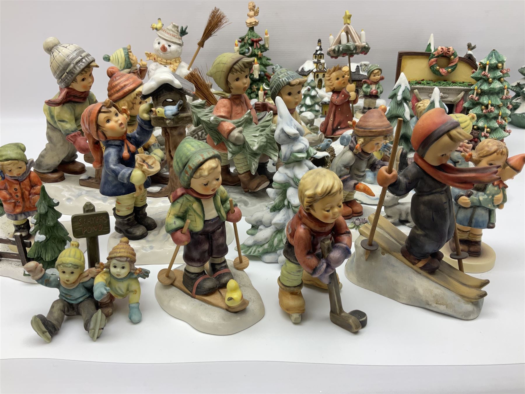 Large collection of Christmas themed Hummel figures and Hummel scapes by Goebel, to include Winter Friend, Making New Friends, Tree Trimming Time, Winter Adventure etc
