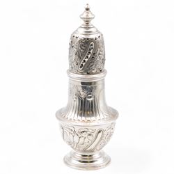 Victorian silver sugar caster, of typical waisted form with engraved and embossed floral and berry decoration, the removable pierced cover with urn finial, upon a circular stepped foot, hallmarked Charles Edwards, London 1884, H20.5cm