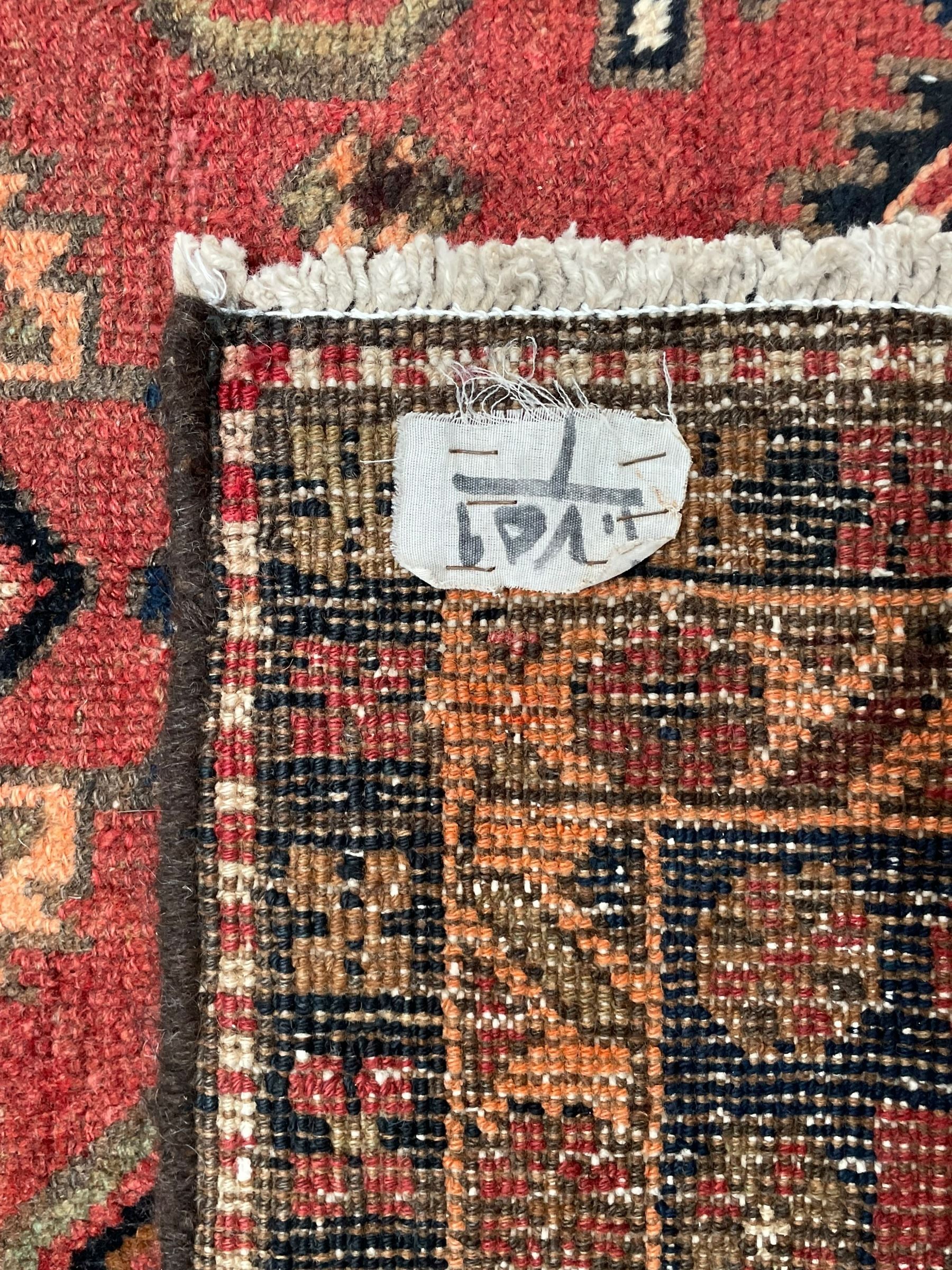 Near pair of Persian Azerbaijan red ground runners, each rug decorated with Nazarlik and stylised leaf motifs, enclosed with three band border decorated with flower heads and geometric motifs 

406cm x 99cm 
409cm x 102cm
