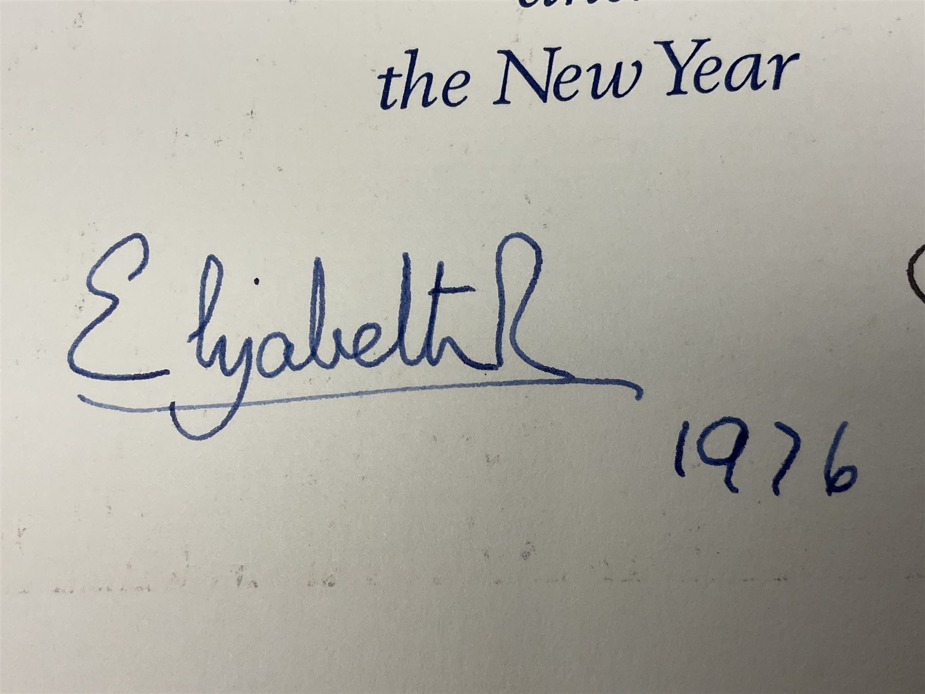 H.M. Queen Elizabeth II and H.R.H. The Duke of Edinburgh, signed 1976 Christmas card with twin gilt Royal cyphers to cover, colour photographic print of the Royal Family to interior, and signatures Elizabeth R and Philip with the manuscript date 1976 below