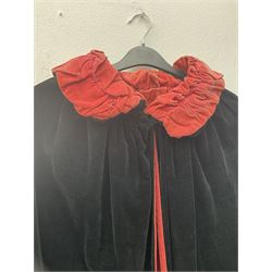 Full length 1930's childs black velvet cape, with ruched collar and red velvet lining, with a single button neck fastening 