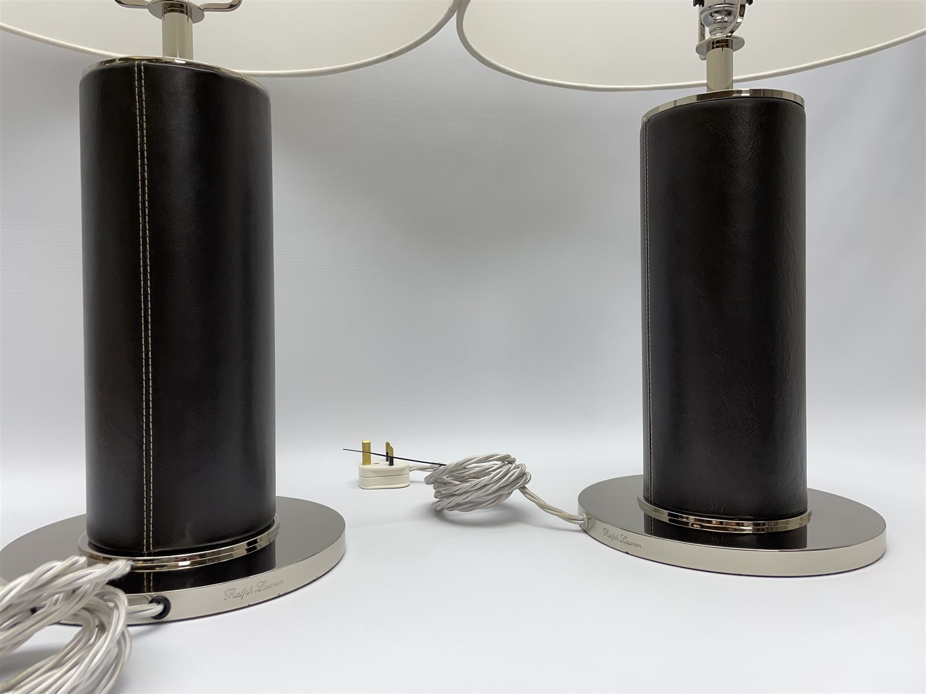 Ralph Lauren - pair 'Beckford' table lamps, cylindrical form in chocolate brown leather, polished metal base, with shades