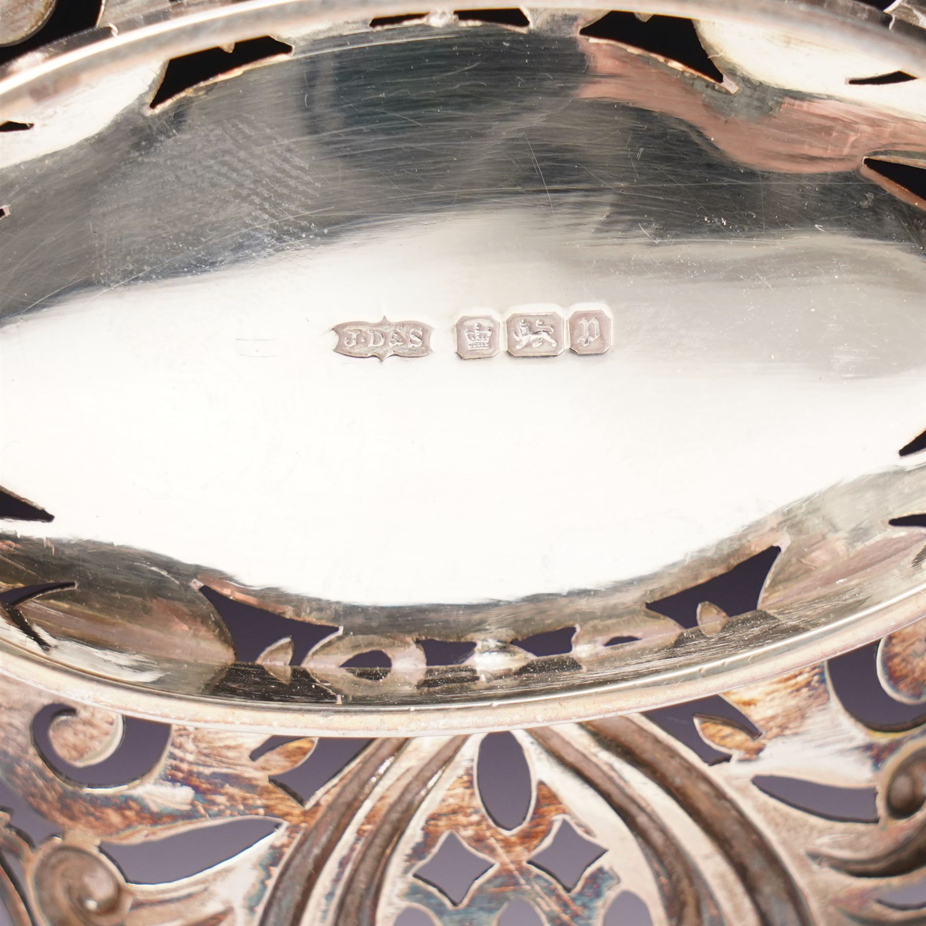Edwardian silver oval dressing table box, the hinged cover embossed with angel heads W10cm London 1902 Maker William Comyns & Sons and an Edwardisn pierced silver oval sweetmeat basket L18cm Sheffield 1907 Maker James Dixon & Sons Ltd
