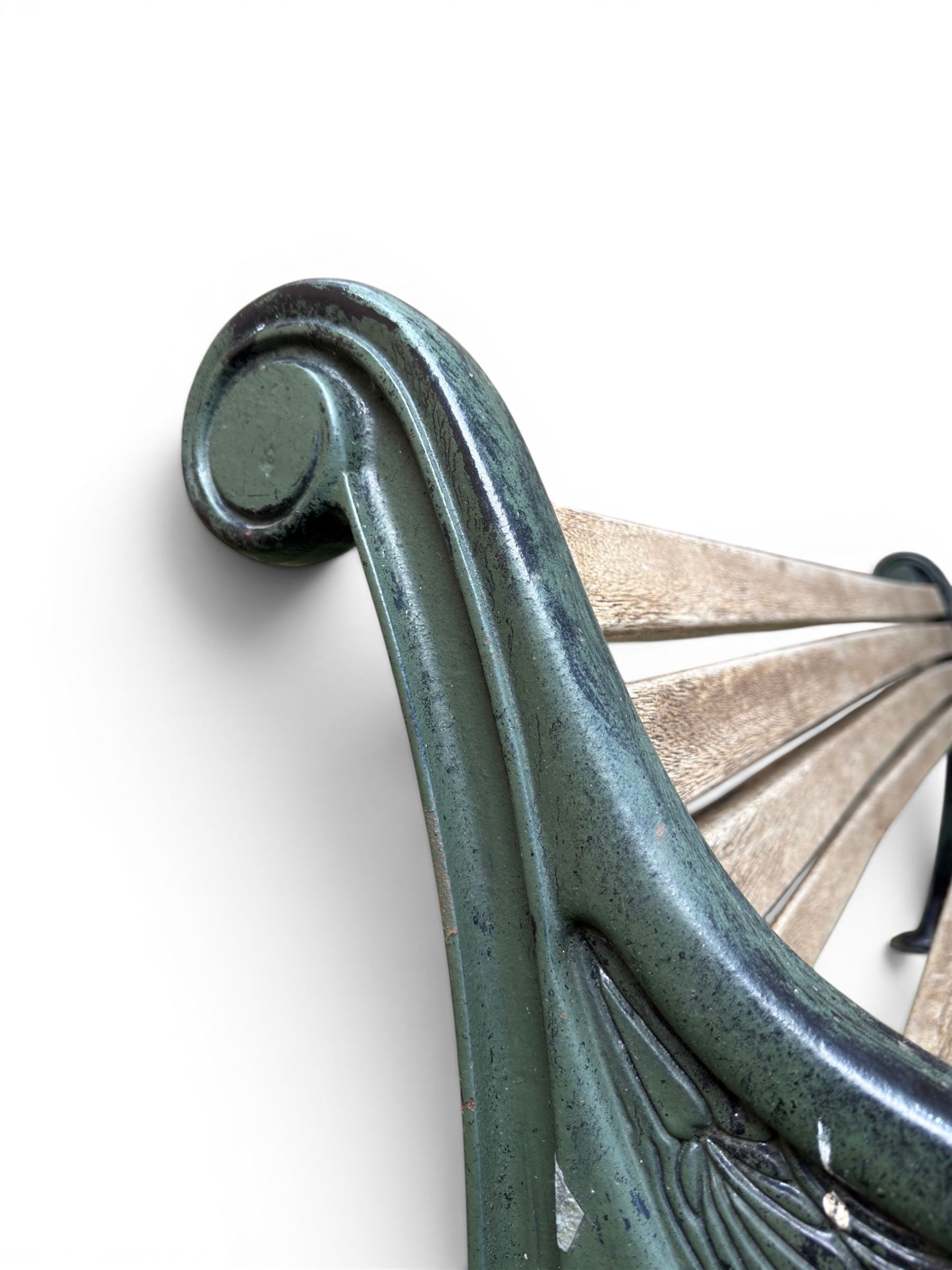 Neoclassical design cast iron and oak slatted garden bench, the twin end supports in the form of a Sphinx with acanthus carved knees and large paw feet, the pierced lattice bracket with Yorkshire rose motifs