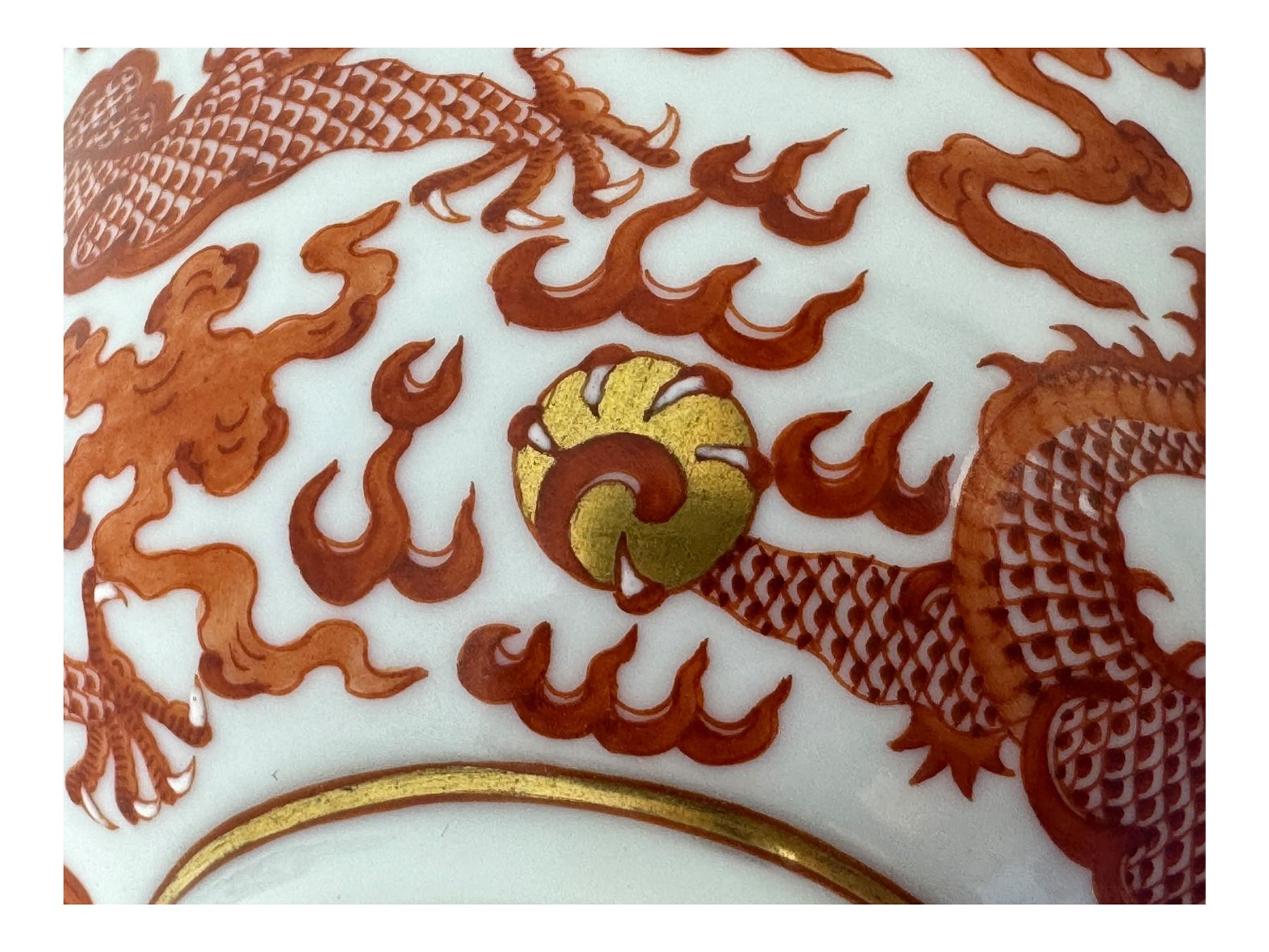 Chinese porcelain iron red tea bowl, the exterior painted with two five claw dragons chasing the flaming pearl, amidst clouds, red Quinlong seal mark beneath, D10.5cm x H6.5cm