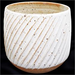 Joanna Constantinidis (1927-2000); studio pottery stoneware vase with fluted body, in a white glaze with brown speckles, impressed C mark to base, H20cm 