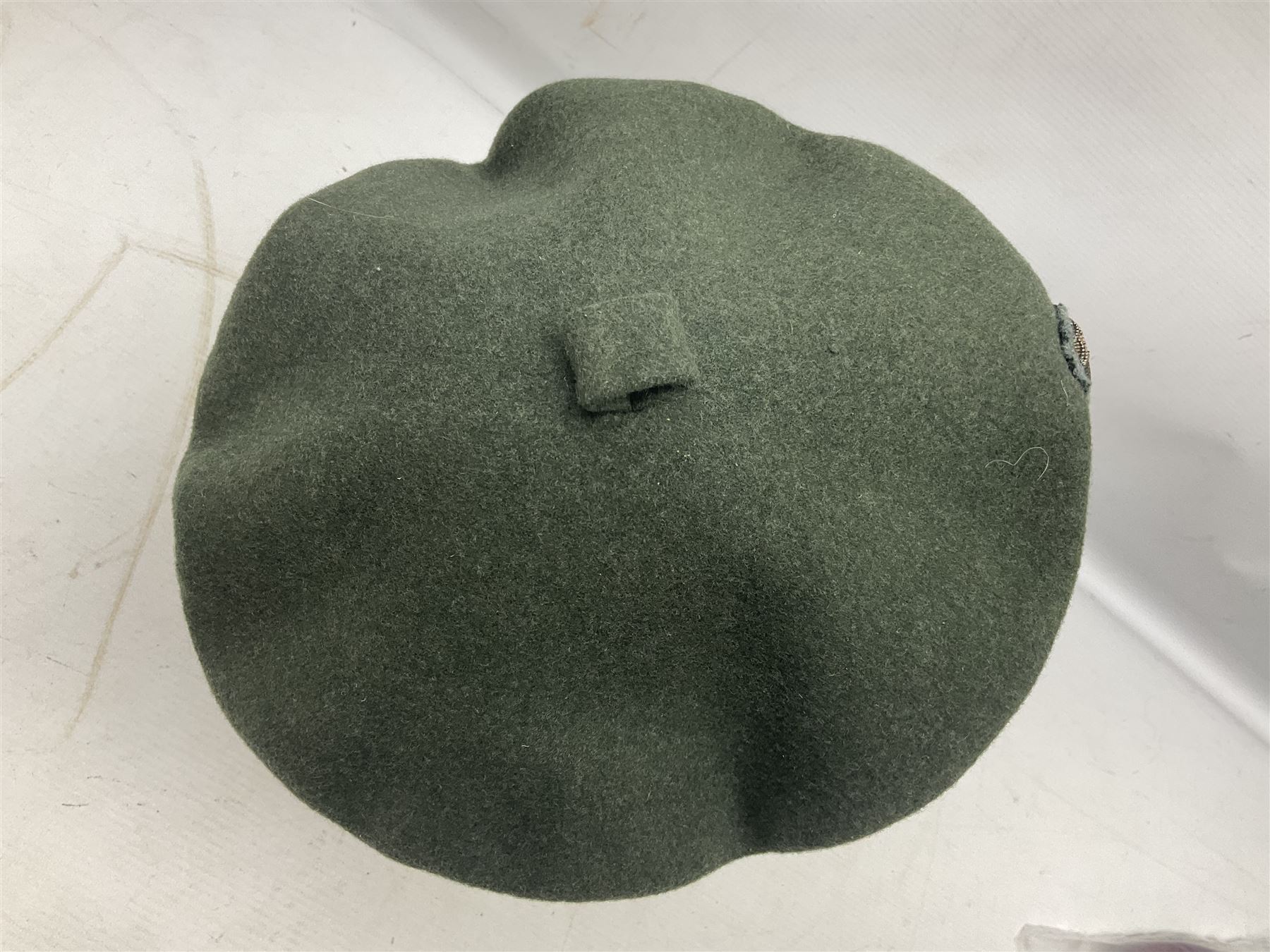 Four paratrooper berets - Russian, Italian, British and Foreign Legion; all with badges (4)