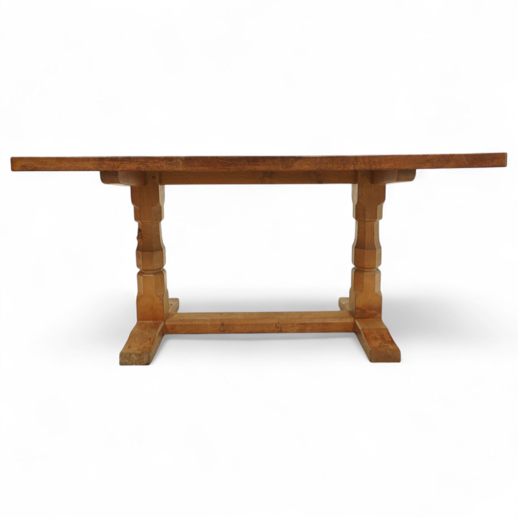 Mouseman - figured oak 5’ refectory dining table, rectangular top with burr figuring, raised on chamfered octagonal supports united by a stretcher, carved mouse signature to leg, by the workshop of Robert Thompson, Kilburn