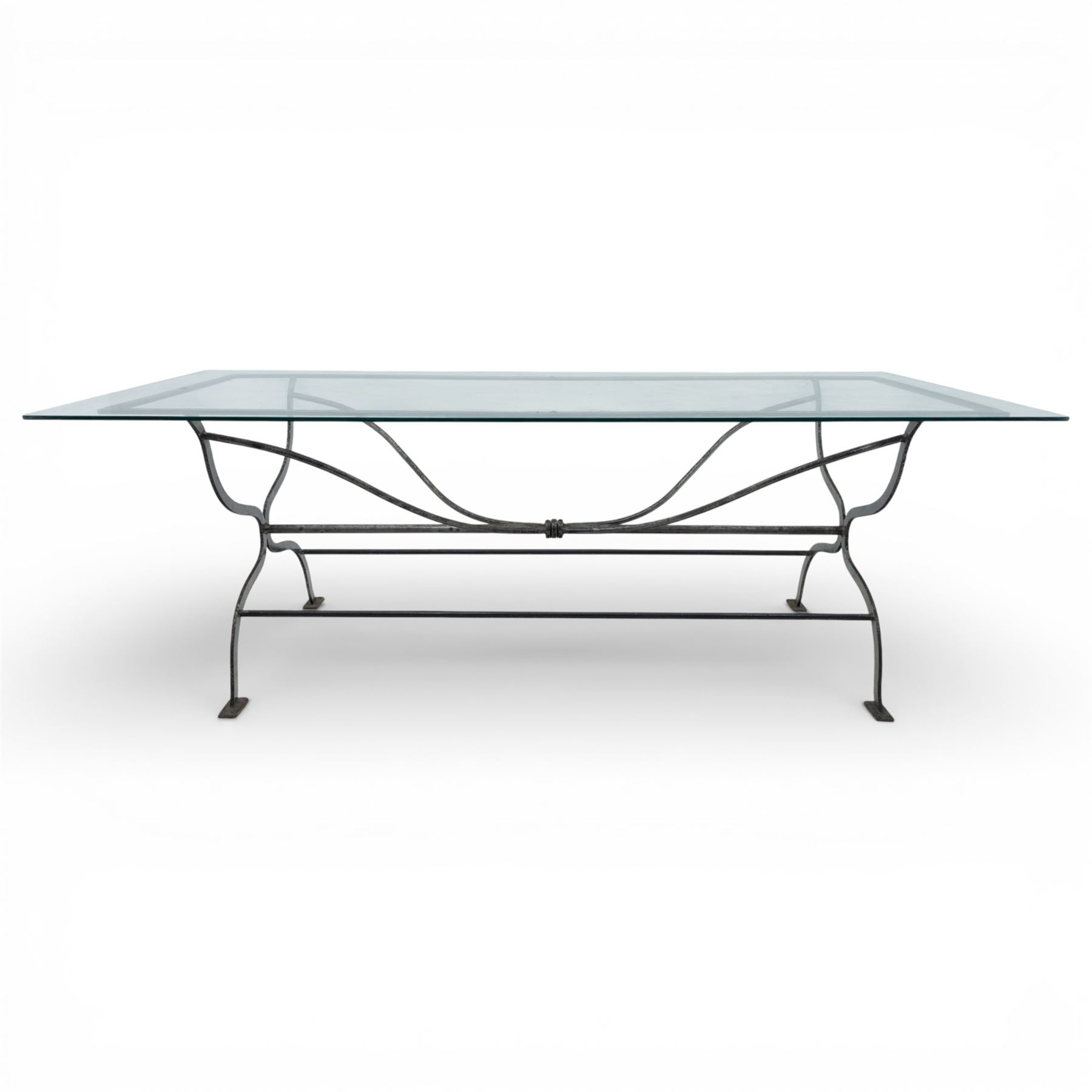 Late 20th century glass dining table, toughened glass top with rounded corners on a wrought metal designed base 