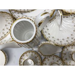 Modern Spode coffee and dinner wares for six place settings, decorated in the Fleur De Lys Gold pattern, comprising dinner plates, dishes, side plates, one handled fan shaped serving dish, coffee pot, coffee cans, saucers, open sucrier and cream jug, with red and black printed marks beneath 